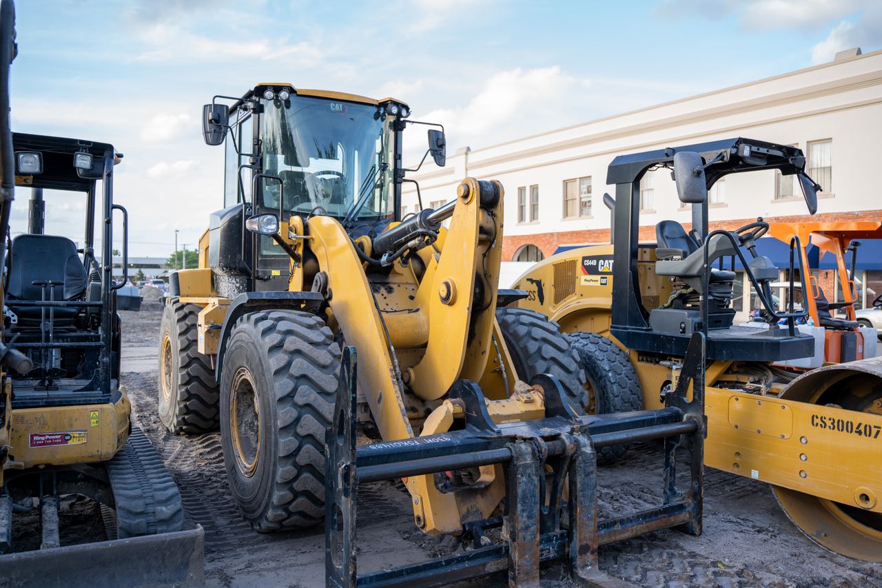 Front view of heavy construction machinery parked in an urban area.